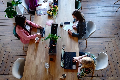 A wheel of laptops and staff working at a table