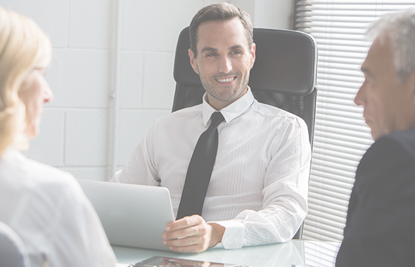 Smiling employee looks at colleague focusing on work item