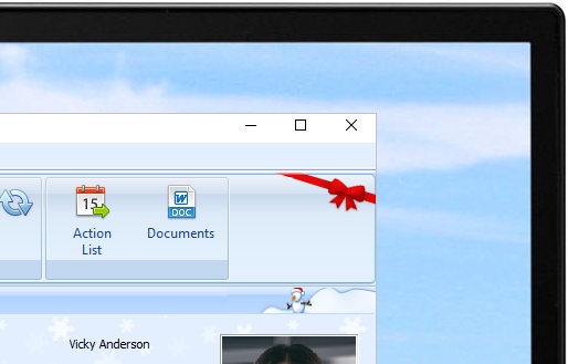 The corner of a laptop with Christmas themed People Inc. HR system open on an employee record