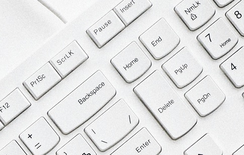A close up of a white keyboard with the home key central