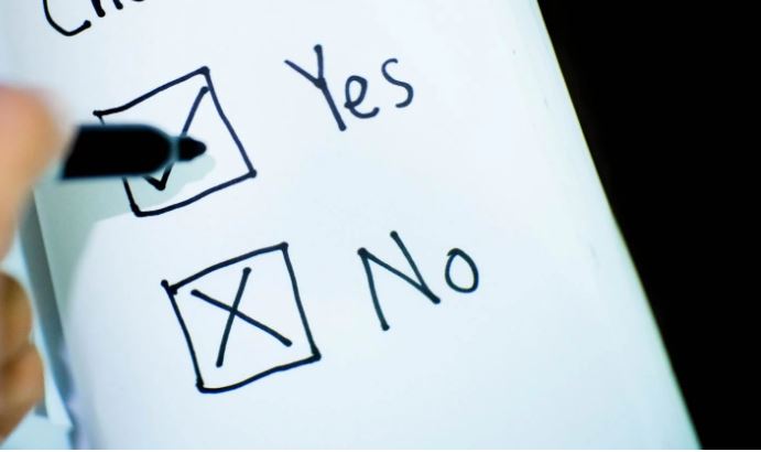 Hand drawn yes and no check boxes with pen ticking yes and no already crossed