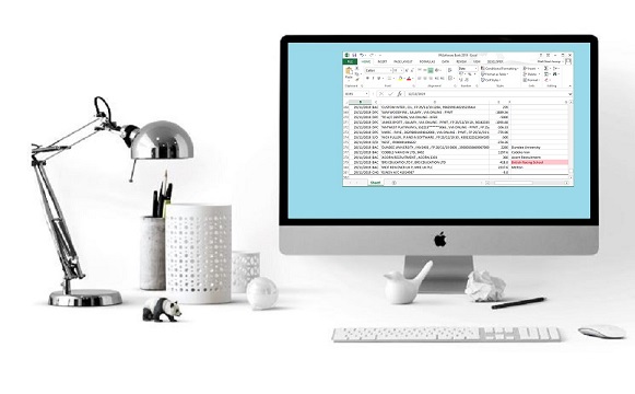 Apple computer sits on white desk with white accessories against a white wall with a silver table lamp peering over a toy Panda. The monitor displays a spreadsheet of data exported from the People Inc system